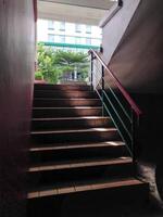 stairs leading upwards with sunlight effect, seen close to the point of view from below. photo