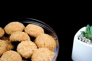 close up view of a beautiful chestnut cake on a black background. photo