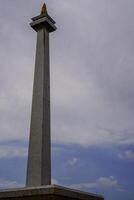 Central Jakarta, January 30, 2024 - National monument with a beautiful background of clouds in the sky during the day. photo