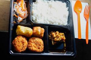 close up of the boxed food on the table. photo