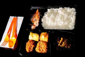 close up of the boxed food on the table. photo