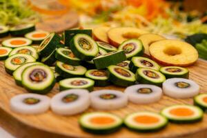 wooden cutting board with a variety of vegetables and fruits photo