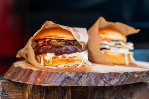 juicy fresh hamburger in a bag on the street photo