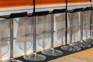 empty bar stools at a bar photo