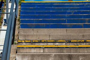 different colored staircase in the city with railing photo