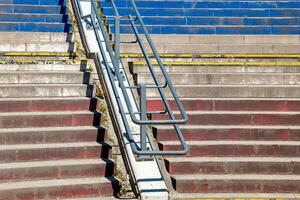 different colored staircase in the city with railing photo