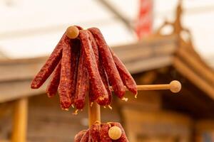 wooden pole with a bunch of sausages photo