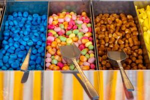 tray of candy with a spoon in each of the three trays photo