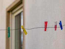 row of colorful clothespins hanging on a line photo