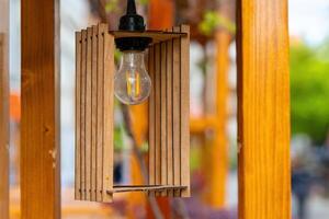wooden lamp with a light bulb inside photo