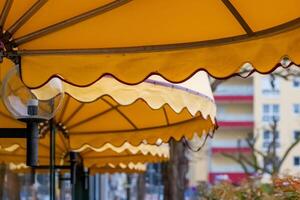 yellow awning in front of a department store in the city photo