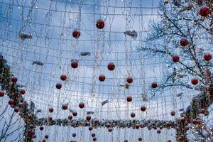 New Year or Christmas festive balls and garlands hanging in rows. photo