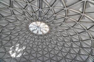 The steel inner part of the roof with the framework of the Chorsu Bazaar in Tashkent. Geometric architectural background. photo