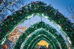 New Year or Christmas festive balls and garlands hanging in rows against the night sky. photo