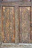 Carved wooden doors with patterns and mosaics. Abstract background for design. photo