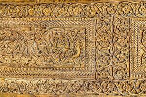 Fragment of an ancient carved wooden door. Ornate. photo