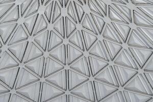 The steel inner part of the roof with the framework of the Chorsu Bazaar in Tashkent. Geometric architectural background. photo