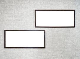 Two picture frames with copy space for text hanging on the wall with wallpaper. Mockup for design. photo