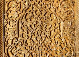 Fragment of an ancient carved wooden door. Ornate. photo