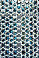 The window of a Muslim mosque behind bars in the form of a geometric hexagonal Islamic ornament. photo