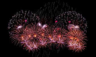 Colorful celebration fireworks isolated on a black sky background. photo