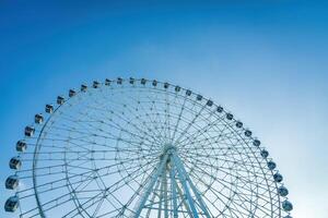 Ferris wheel at sunset or sunrise in an amusement park. photo