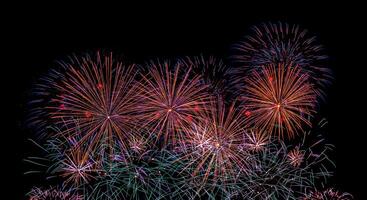 Colorful celebration fireworks isolated on a black sky background. photo