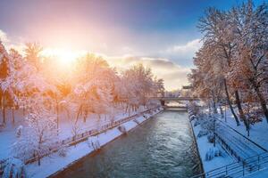 Sunset or dawn on a canal with non-freezing water on a cold winter day. photo