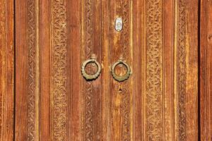 Carved wooden doors with patterns and mosaics. photo