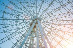 Ferris wheel at sunset or sunrise in an amusement park. photo