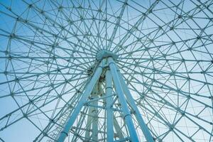 Ferris wheel at sunset or sunrise in an amusement park. photo