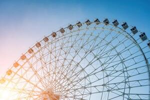 Ferris wheel at sunset or sunrise in an amusement park. photo