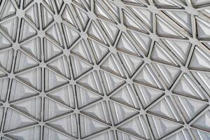 The steel inner part of the roof with the framework of the Chorsu Bazaar in Tashkent. Geometric architectural background. photo