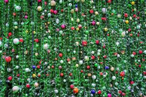 Christmas balls, toys and glowing garlands on an artificial spruce. photo