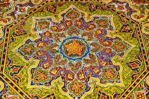 Colorful vintage oriental ornament painted on the tabletop. Abstract background. photo