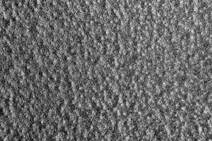 Monochrome texture of shiny grained metal. Abstract background. photo