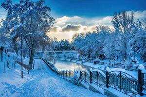 Sunset or dawn on a canal with non-freezing water on a cold winter day. photo