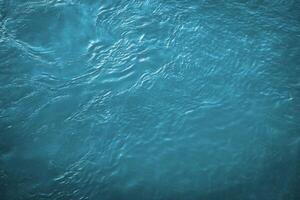 The texture of the waves of blue color of fast-flowing water in the river. photo