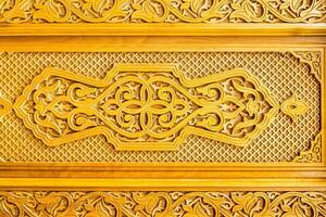 Fragment of an ancient carved wooden door. Ornate. photo