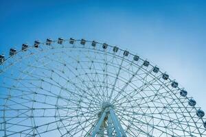 Ferris wheel at sunset or sunrise in an amusement park. photo