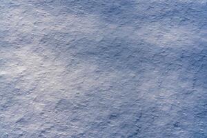 textura de nieve iluminado por luz de sol. foto