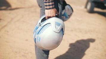 a man in the steppe holds a motorcycle helmet in his hand video