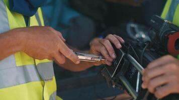 Installing a camera on a crane. A man sets up a platform on a movie camera video