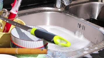 close up of hand doing dish washing in the modern kitchen sink. High quality 4k footage video