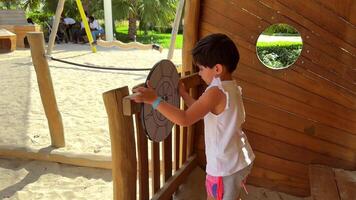 Childhood, play, training, self-isolation concept - close-up dark-haired curly little six-year-old girl of Persian Middle Eastern video