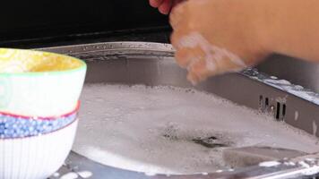 close up of hand doing dish washing in the modern kitchen sink. High quality 4k footage video