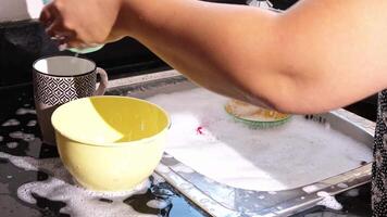 close up of hand doing dish washing in the modern kitchen sink. High quality 4k footage video