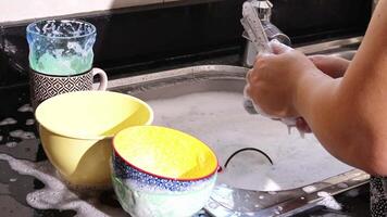 close up of hand doing dish washing in the modern kitchen sink. High quality 4k footage video