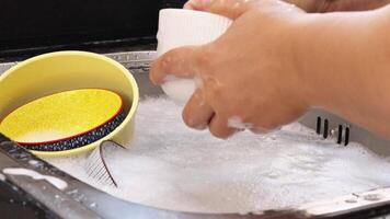 close up of hand doing dish washing in the modern kitchen sink. High quality 4k footage video