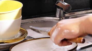 close up of hand doing dish washing in the modern kitchen sink. High quality 4k footage video